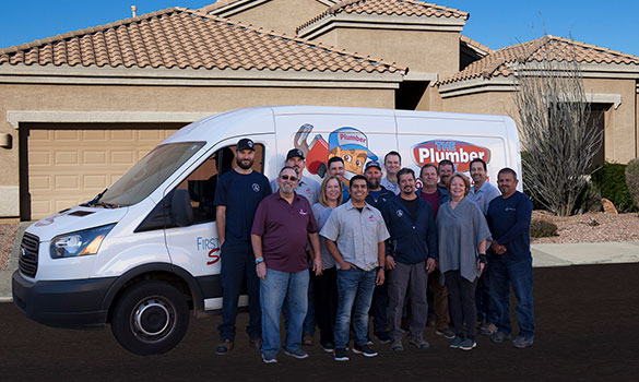 The Plumber Guy team poses near one of their work trucks.