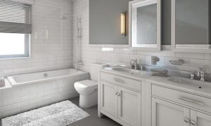 A luxury bathroom with modern toilet, bathtub, and double sinks