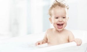 A laughing baby in the bath.