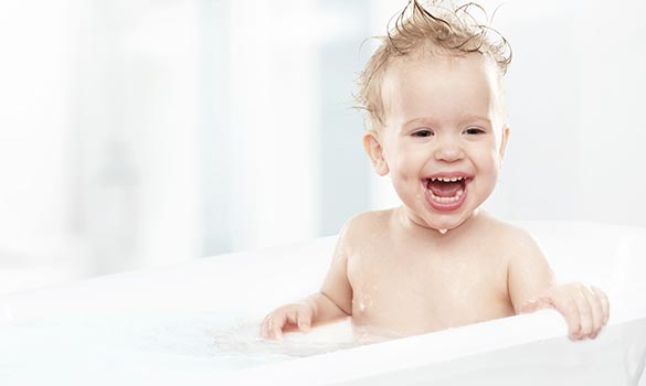 A happy child in a bathtub.